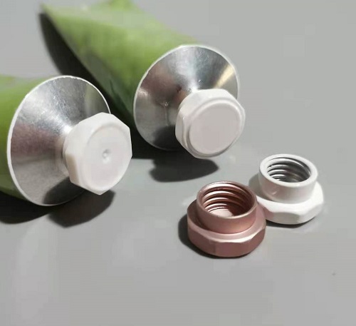 White metal caps of aluminum tubes for hand cream